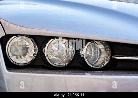 Headlight with halogen lamp on modern gray car, close up Stock Photo