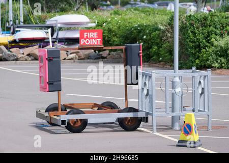 Fire assembly point sign in car park signpost Stock Photo