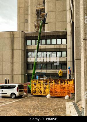 Two construction workers working with a crane  at site Stock Photo