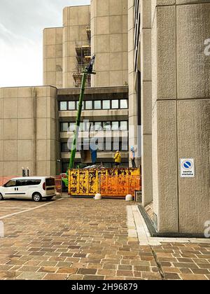 Two construction workers working with a crane  at site Stock Photo
