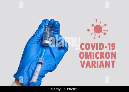 A doctor holds vaccine against new covid-19 omicron variant. New generation vaccine against Coronavirus South African variant. Omicron variant of SARS Stock Photo