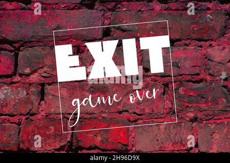 White exit word and game over. letters on brick wall. gaming concept Stock Photo