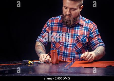 Leather Skinner cutting out leather shapes for a new product Stock Photo