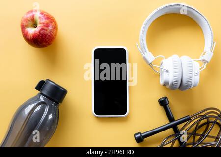 Flat lay composition with sports equipment on yellow background. Stock Photo