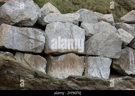 Huge stone blocks lying on Fistral Beach Cornwall, England Stock Photo