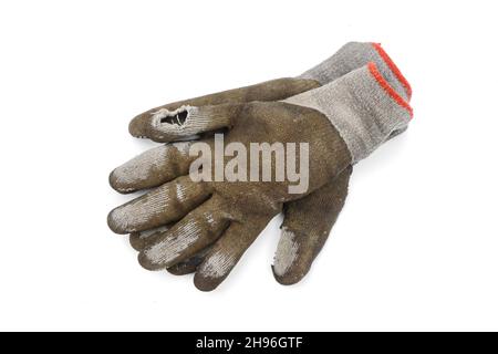 Used old dirty torn worker's gloves isolated on white background. Stock Photo