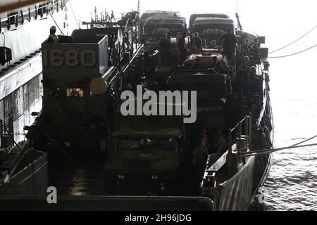 A landing craft utility enters the well deck of the amphibious assault ...
