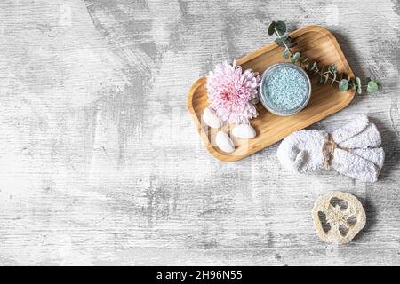 Flat lay spa composition with body products on textured concrete background. Stock Photo