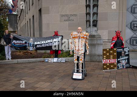 Frank Huntley has been trying to raise awareness of opiate addiction with his sculpture 'Pill Man. On December 3, 2021, people from across the United States, who lost loved ones due to the opioid epidemic, rallied at the Department of Justice in Washington DC, calling on Attorney General Merrick Garland and Deputy AG Lisa Monaco to bring criminal charges against members of the Sackler family. The Sackler's company, Purdue Pharma, pleaded guilty in October of 2020, to three criminal charges related to its marketing of the drug OxyContin but have only faced monetary penalties of around $8.3 bill Stock Photo