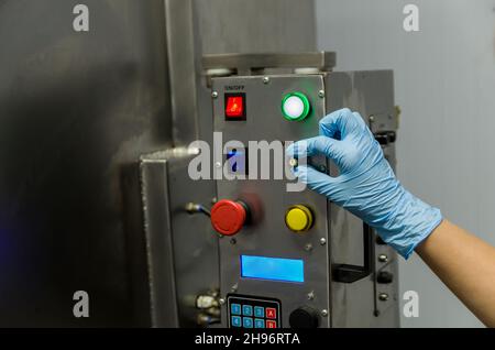 Woman working in industry, adjusting equipament Stock Photo