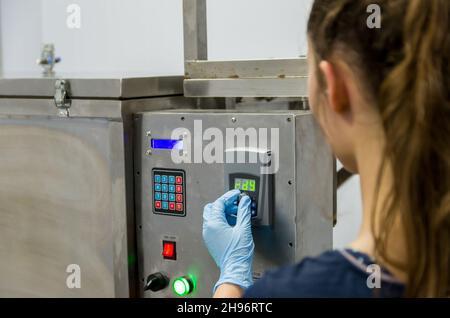 Woman working in industry, adjusting equipament Stock Photo