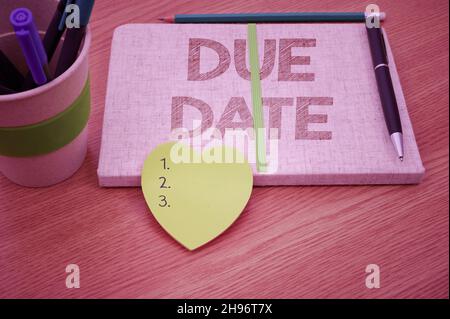 Sign displaying Due Date. Internet Concept The date when payment should be received by the person or company Plain Blank Open Notebooks With Stack Of Stock Photo