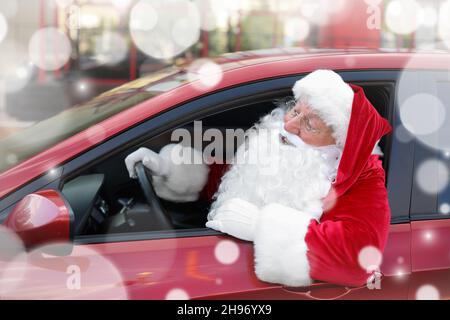 Santa Claus leaning out of car window on winter day Stock Photo