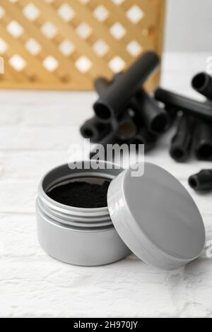 Jar with activated charcoal tooth powder on table Stock Photo