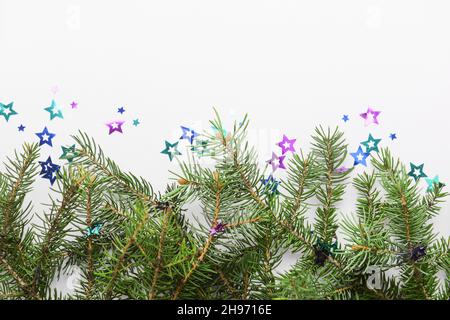 Christmas branches and confetti on white background Stock Photo