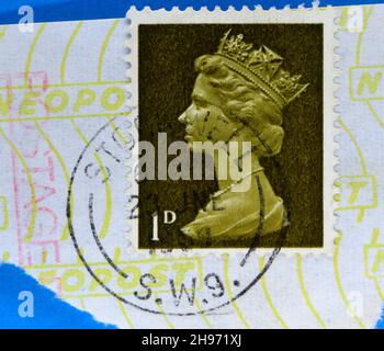 Photo of a brown postage stamp 1d with Queen Elizabeth II in profile Stock Photo