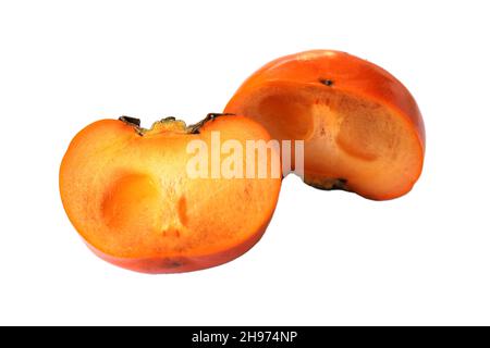 Ripe persimmons are cut in half separately placed on a white background. The polarity of the fruit is brown. Stock Photo