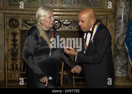 Singer-songwriter Joni Mitchell, left, and Motown founder, songwriter, producer and director Berry Gordy, right, both recipients of the 44th Annual Kennedy Center Honors in discussion following their posing for a group photo following the Medallion Ceremony at the Library of Congress in Washington, D.C. on Saturday, December 4, 2021. Credit: Ron Sachs / Pool via CNP Stock Photo