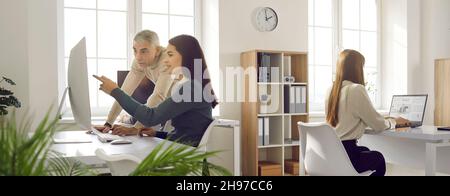 Banner with business people working on computers in cosy modern office workspace Stock Photo