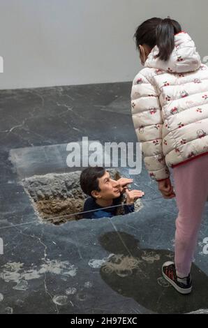 Beijing, China. 05th Dec, 2021. Man looking out of underground tunnel at Maurizio Cattelan The Last Judgment art exhibition in UCCA Center for Contemporary Art in Beijing, China on 05/12/2021 by Wiktor Dabkowski Credit: dpa/Alamy Live News Stock Photo