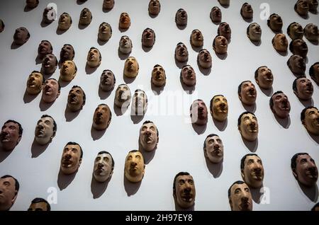 Beijing, China. 05th Dec, 2021. Multiplied faces stuck to the wall at Maurizio Cattelan: The Last Judgment art exhibition in UCCA Center for Contemporary Art in Beijing, China on 05/12/2021 by Wiktor Dabkowski Credit: dpa/Alamy Live News Stock Photo