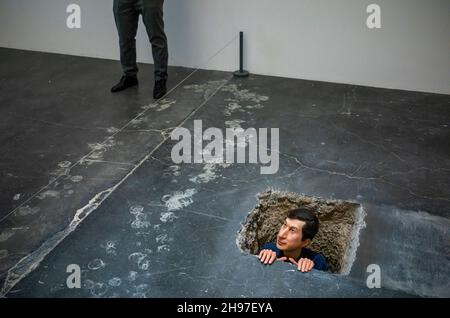 Beijing, China. 05th Dec, 2021. Man looking out of underground tunnel at Maurizio Cattelan The Last Judgment art exhibition in UCCA Center for Contemporary Art in Beijing, China on 05/12/2021 by Wiktor Dabkowski Credit: dpa/Alamy Live News Stock Photo