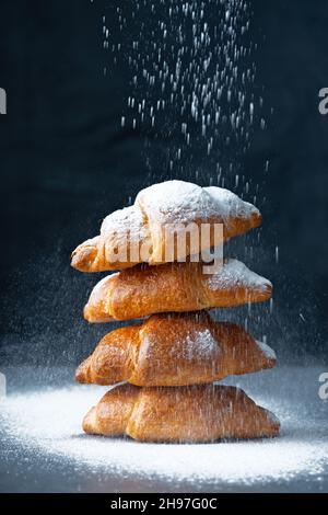 Close up of pile of delicious croissants on a blue background. Stock Photo