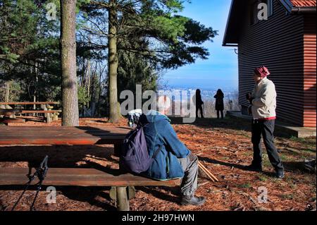 Senior couple resting on a bench after hiking Stock Photo