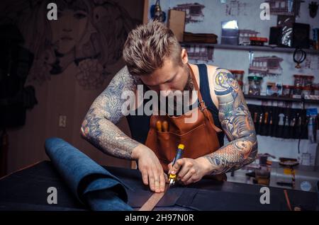 Man working with leather produces leather goods Stock Photo