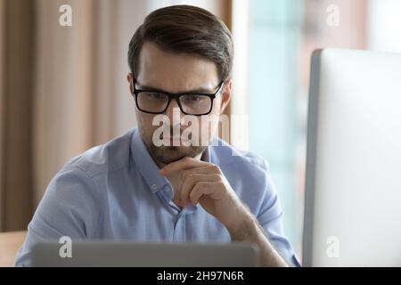 Focused business professional man in glasses working on project Stock Photo