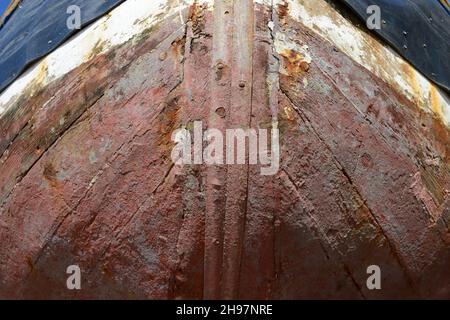 Hull of a boat left high and dry on the sand by the receding tide at Barry, south Wales, UK Stock Photo
