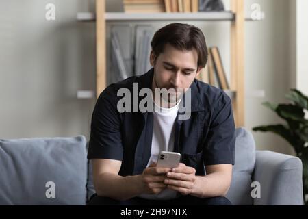 Focused cell user reading text message on mobile phone screen Stock Photo