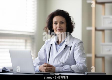 Confident successful mature female doctor, general practitioner Stock Photo