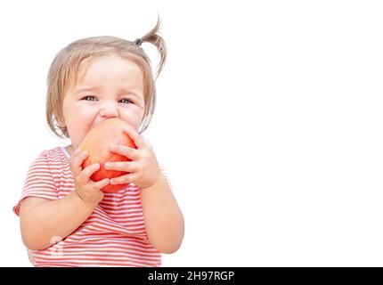 Child bites off an apple isolated on white background Stock Photo