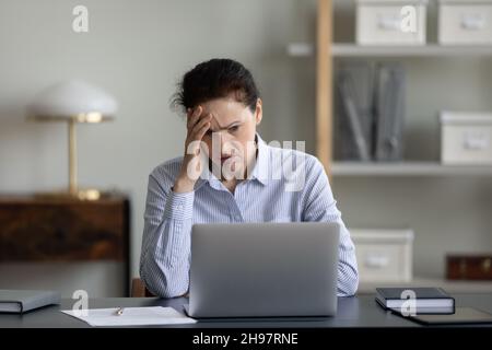 Frustrated stressed senior business woman using laptop Stock Photo