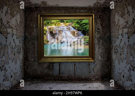 The image of a waterfall hang on the wall in an abandoned damaged room. Stock Photo