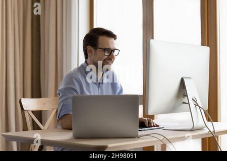 Happy male business professional leader working at workstation monitor Stock Photo