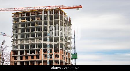 Construction of a frame building, skeleton of a high-rise house. Copy space. Stock Photo