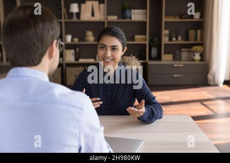 Happy Indian female client consulting male business professional Stock Photo