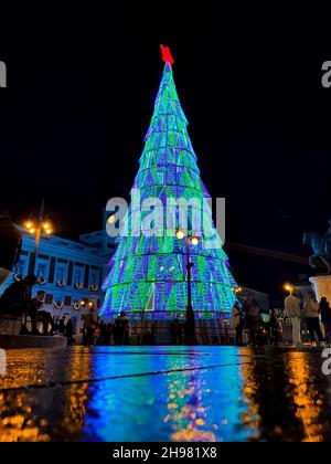 Christmas tree with colored lights next to La Puerta del Sol in Madrid. in Spain. Europe. Vertical Photography. Stock Photo