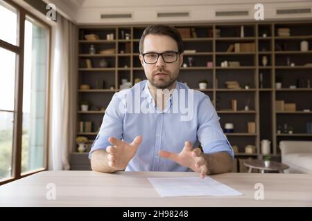 Serious confident millennial business professional in glasses looking at camera Stock Photo