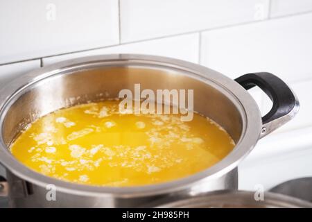 Melt the butter in a stainless saucepan. Cooking ghee. Stock Photo