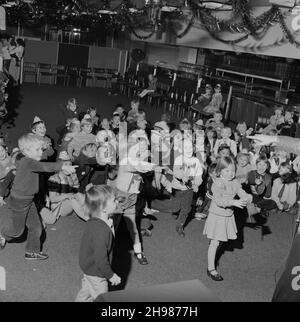 John Laing and Son Limited, Page Street, Mill Hill, Barnet, London, 10/12/1983. An audience of children participating during the entertainment at the Laing children's Christmas party at Mill Hill. This photograph was published in January/February 1984 in Laing's monthly newsletter 'Team Spirit'. It shows children of Laing sports club members participating in entertainment provided by 'Poz' the magician at their annual Christmas party. Stock Photo