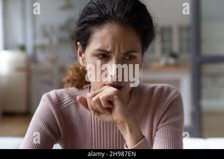 Close up thoughtful upset woman thinking about problems alone Stock Photo