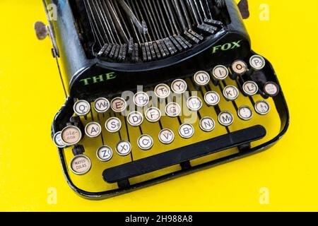 The Fox vintage typewriter on yellow background Stock Photo