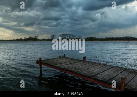 Footbridge over the lake and cloudy sky, Stankow, Poland Stock Photo