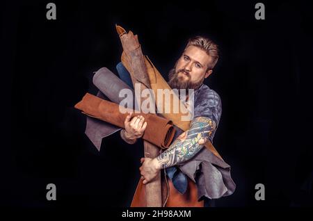 Craftsman working with leather forms new leather product Stock Photo