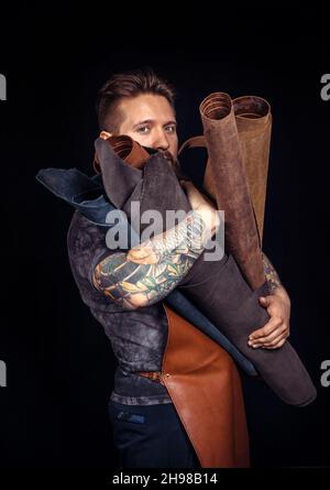 Skinner wording with leather goods in leather shop Stock Photo