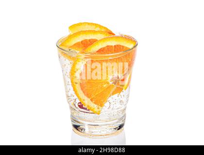 a slice of orange with bubbles in a glass of sparkling water. Close-up. Stock Photo