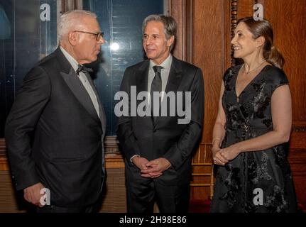 David M. Rubenstein, chairman of the Kennedy Center for the Performing Arts, left, speaks with United States Secretary of State Antony Blinken, center and Blinken's wife, Evan Ryan following the Medallion Ceremony at the Library of Congress in Washington, DC on Saturday, December 4, 2021.Credit: Ron Sachs/Pool via CNP /MediaPunch Stock Photo